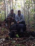 Dale Stafford with Mark Sundeen 412# black bear shot on ground with hounds. Yellow River Flyway LLC. (Dog Sonny pictured with bear)